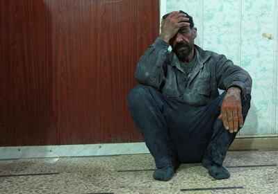 A Syrian man awaits to be treated at a makeshift hospital in the rebel-held town of Douma, in the besieged Eastern Ghouta region on the outskirts of the capital Damascus, following air strikes by regime forces on the area on March 2, 2018. / AFP PHOTO / HAMZA AL-AJWEH