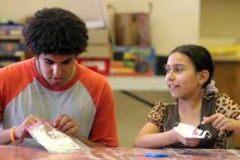 Mokhtar Bdeir, 16, left, and Warda Abuali, 11, right, work on their embroidery skills during an art class at Al-Bustan summer camp on Friday, July 18, 2008 in Chestnut Hill, Pennsylvania. (Jessica Kourkounis for The National) *** Local Caption ***  AL_BUSTAN20.JPG