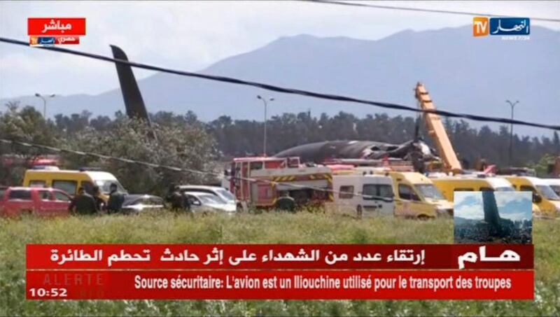 In this still taken from TV showing emergency services at the scene after a military plane crashed soon after takeoff at Boufarik military base, Algeria, Wednesday April 11, 2018. At least 100 people were killed when a military plane crashed soon after takeoff in a farm field in northern Algeria on Wednesday, officials said. (ENNAHAR TV via AP) LOGO CANNOT BE OBSCURED : EDS NOTE NO TRANSLATION AVAILABLE FOR ON SCREEN TEXT
