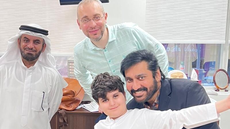 Ibrahim, aged nine, celebrates with his father Abdulla Al Awadi and doctors after a 60g tumour was removed from his nasal cavity. Photo: Medcare