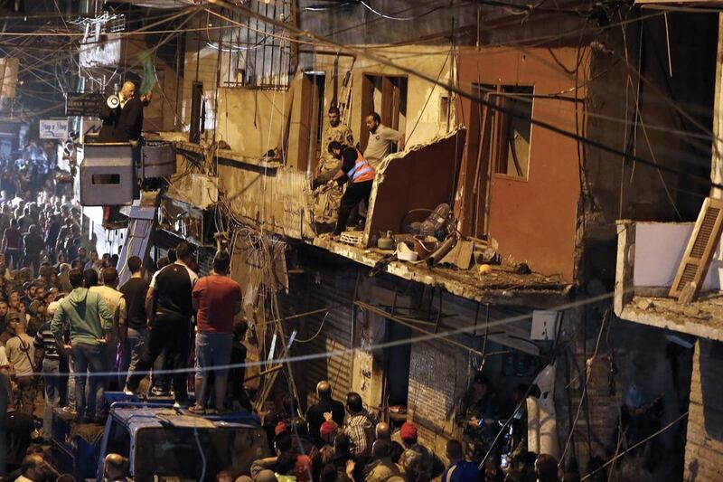 Lebanese soldiers and civilians gather near the site of an ISIS-claimed twin bombing in the area of Burj Al Barajneh in Beirut's southern suburbs on November 13, 2015. EPA