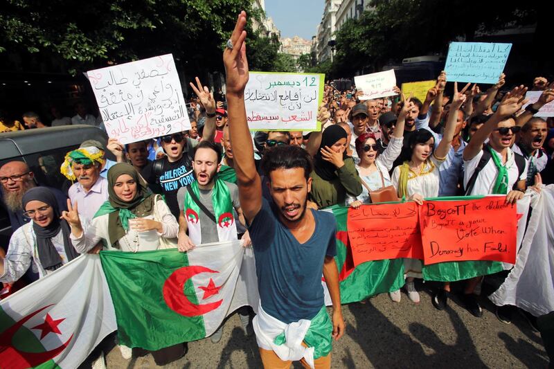 Demonstrators carry flags and banners during a protest rejecting Algerian election announcement for December, in Algiers, Algeria. REUTERS