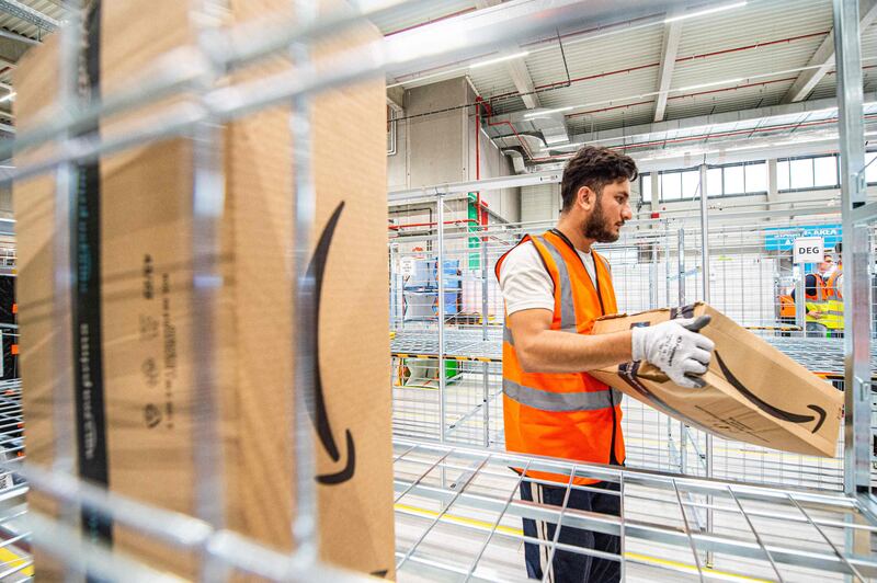 An employee at the first Belgian delivery centre of Amazon in Antwerp. The e-commerce major has halted 'new incremental' hiring across its workforce. AFP