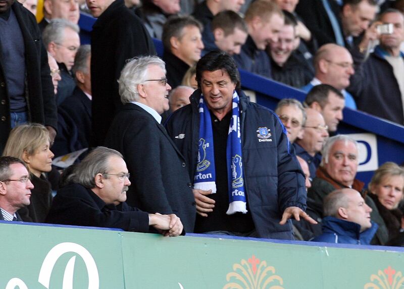 US actor Sylvester Stallone (R) takes a seat next to Everton chairman Bill Kenwright (C) before the Everton versus Reading English Premiership football match at Goodison Park, Liverpool, north-west England, 14 January 2007. The actor, famous for his roles in the Rocky films, was a guest of the club as he is promoting his new film 'Rocky Balboa'. PHOTO/PAUL ELLIS (Photo by PAUL ELLIS / AFP)