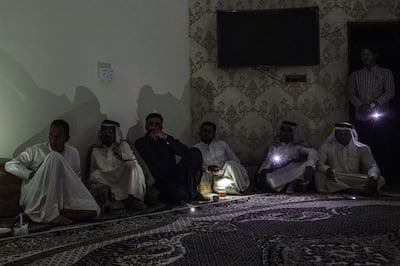 Residents of Nasiriyah attend a meeting with election candidate Alaa Al Rikabi during one of the frequent power cuts in the southern Iraqi city. Haider Husseini / The National                                                                       