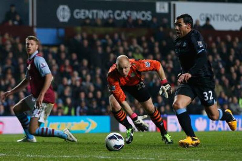 Manchester City's Carlos Tevez breaks past Brad Guzan to score against Aston Villa.