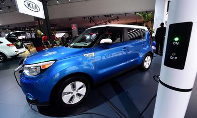 The 2015 Kia Soul EV is shown while charging on display at the LA Auto Show's press and trade day in Los Angeles November 20, 2014. The LA Auto Show opens to the public on November 21 will run until November 30. AFP PHOTO/Frederic J. BROWN / AFP PHOTO / FREDERIC J. BROWN