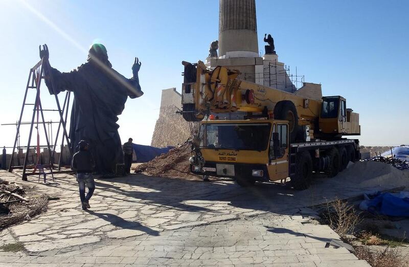 Workers prepare to install a statue of Jesus on Mount Sednaya, Syria. Samir El Gadban / AP

