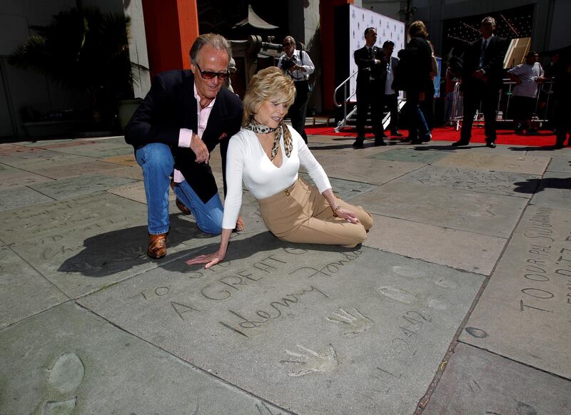 Jane and Peter Fonda look at their father's hand and footprints after her hand and footprint ceremony in the forecourt of the Chinese theatre in Hollywood, California in 2013. Reuters.