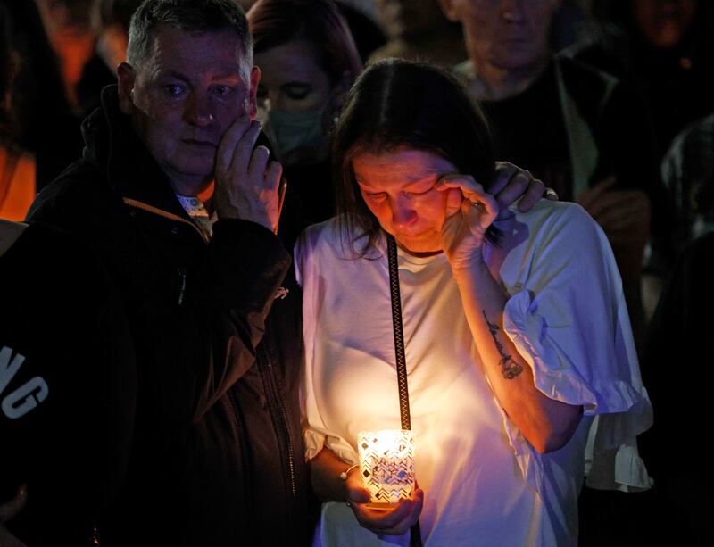 People shed tears at a vigil in Kidbrooke. AP Photo