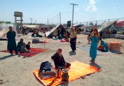 Afghan families sit outside their tents in an open area on the outskirts of Chaman, a border town in Pakistan. AP