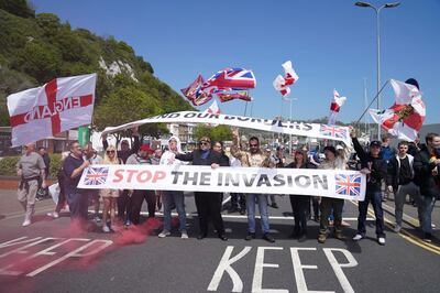 People take part in an anti-immigration protest in Dover, England, Saturday, May 29, 2021, demonstrating against the journeys made by refugees crossing the English Channel to Kent. (Andrew Matthews/PA via AP)