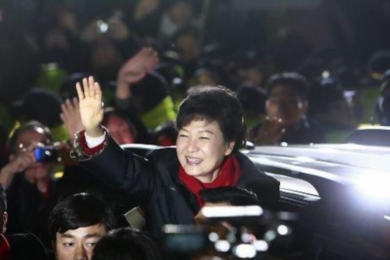 South Korean presidential election winner Park Geun-Hye waves to supporters outside the Saenuri Party office after being declared victorious after election returns in Seoul.