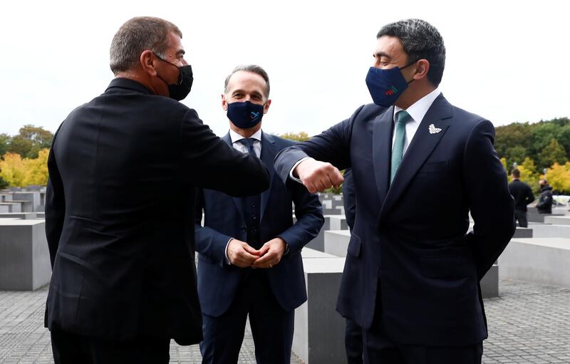 UAE Foreign Minister Sheikh Abdullah bin Zayed al-Nahyan and his Israeli counterpart Gabi Ashkenazi greet as they visit the Holocaust memorial together with German Foreign Minister Heiko Maas prior to their historic meeting in Berlin, Germany October 6, 2020.  REUTERS/Michele Tantussi