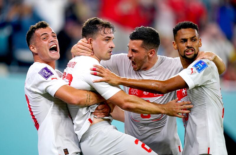 Switzerland's Xherdan Shaqiri, second left, celebrates with teammates after scoring. PA