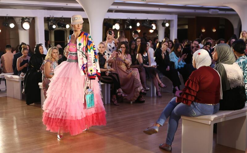 epa06724018 A model displays a creation from the collection of House of MuaMua from Italy, presented during the first floating fashion week experience of Arab Fashion Week held at Queen Elizabeth II Ship in Port Rashid Dubai, United Arab, 09 May 2018.  EPA/ALI HAIDER