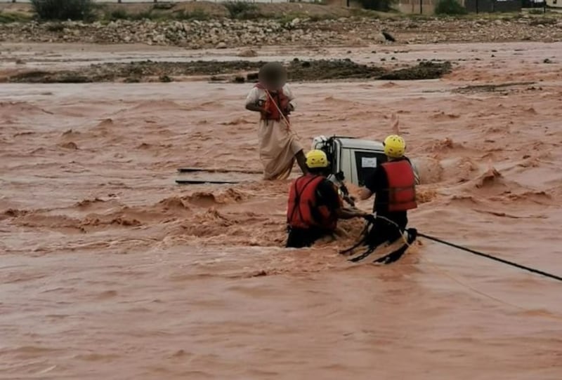 Civil defence workers rescued three people after their vehicle was stranded in a flooded wadi. Photo: Oman Civil Defence and Ambulance Authority