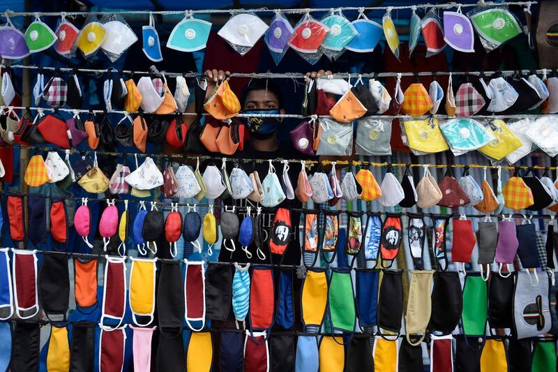 A vendor arranges facemasks to sell on a roadside in Hyderabad.  AFP