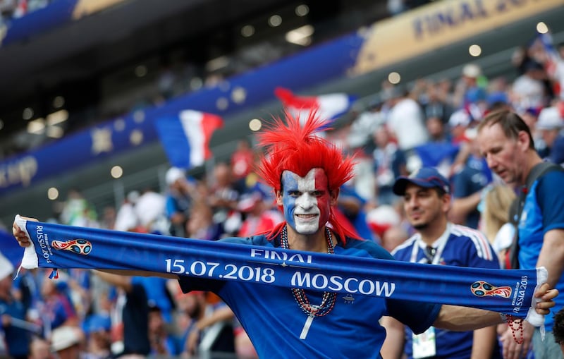 A French fan hold up a souvenir scarf as he waits for the start of the final match between France and Croatia. AP Photo