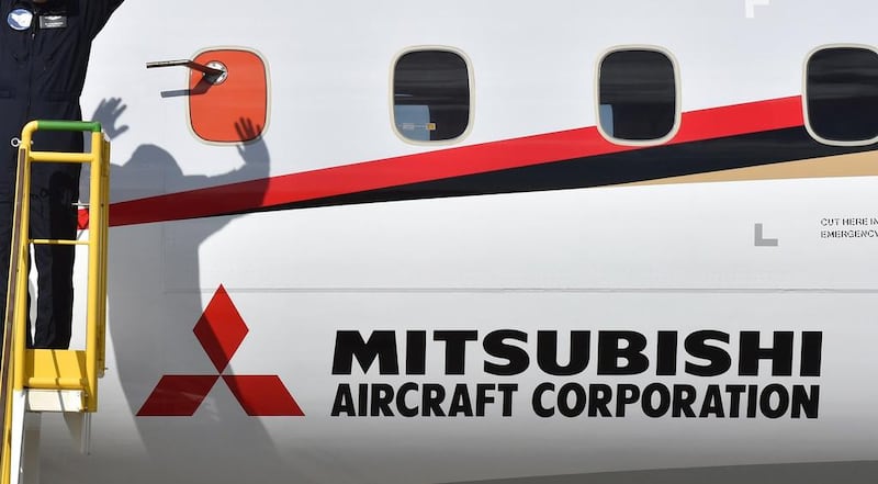 The Mitsubishi Aircraft Corporation logo is seen on the fuselage of Japan's new passenger jet, the Mitsubishi Regional Jet (MRJ), at Nagoya airport in Komaki, Aichi. Japan's first domestic passenger set off on its flight to the US today for testing after two previous attempts were abandoned. Kazuhiro Nogi /   AFP 
