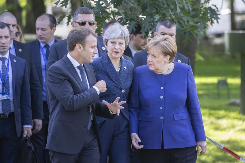 Emmanuel Macron, Theresa May, and Angela Merkel walk in the gardens of the National Palace of Culture ahead of a summit of European Union leaders in Sofia, Bulgaria, May 17, 2018. Bloomberg