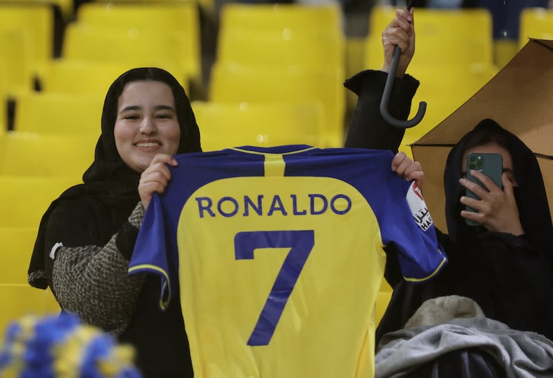 An Al Nassr fan poses with a Cristiano Ronaldo's jersey. Reuters