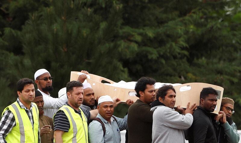 People attend the burial ceremony of Hussein Mohamed Khalil Moustafa, 70, at the Memorial Park Cemetery in Christchurch. Reuters