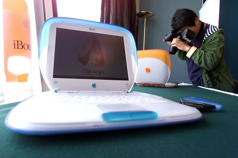 A local journalist photographs the new Apple Computer iBook at the computer's Hong Kong launch 27 October 1999.  The moderately priced laptop aimed at the student and home use market features a G3 processor running at 300MHz and will be available in the territory starting next month for HKD 13,100 (USD 1,712).  Apple is hoping to further increase its market share in Hong Kong with the new laptop modelled on the desktop iMac which proved surprisingly popular when it was released here last year. (ELECTRONIC IMAGE) AFP PHOTO (Photo by ROBYN BECK / AFP)