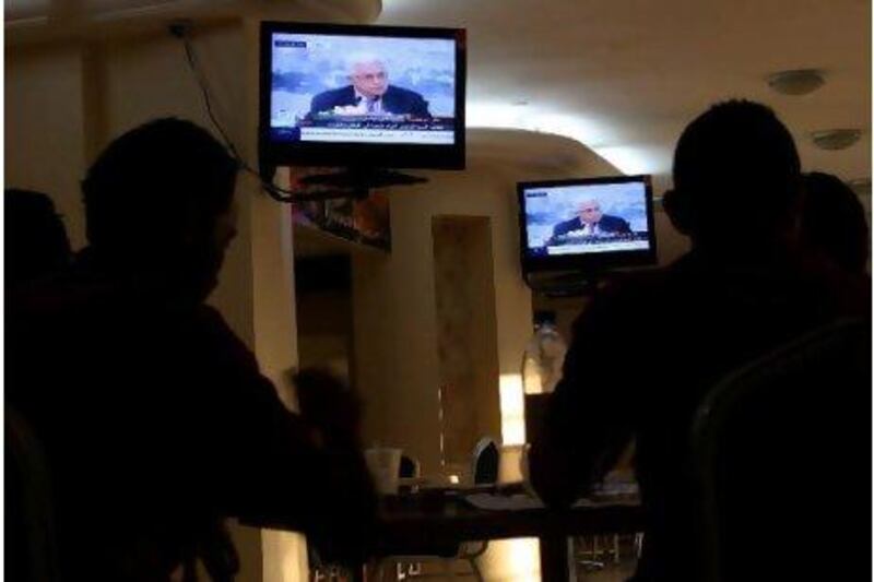 Palestinians watch Mahmoud Abbas give a speech saying he will ask the UN for Palestinian statehood recognition.