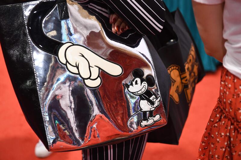 An attendee carries a Mickey Mouse shoulder bag at the D23 Expo, billed as the 'largest Disney fan event in the world'. AFP.