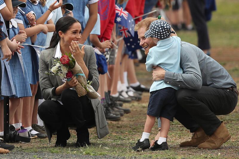 Prince Harry, Duke of Sussex and Meghan, Duchess of Sussex, meet with local children as they arrive at Dubbo Airport on October 17, 2018 in Dubbo, Australia. Getty Images