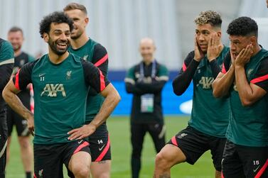 Liverpool's Mohamed Salah, left, smiles as Liverpool's Alex Oxlade-Chamberlain, right, and Liverpool's Roberto Firmino look on during a training session at the Stade de France in Saint Denis near Paris, Friday, May 27, 2022.  Liverpool and Real Madrid are making their final preparations before facing each other in the Champions League final soccer match on Saturday.  (AP Photo / Manu Fernandez)