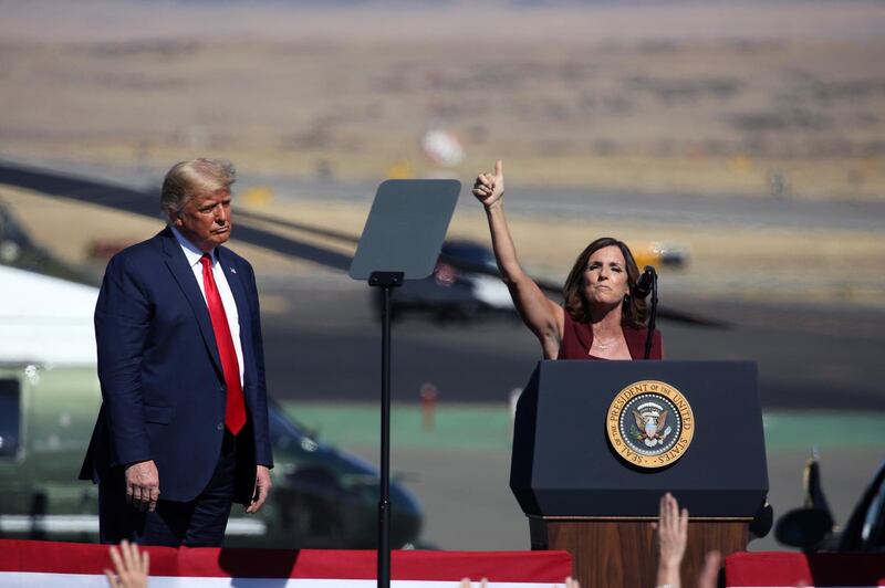 PRESCOTT, AZ - OCTOBER 19: U.S. President Donald Trump watches as Senator Martha McSally (R-AZ) speaks at a Make America Great Again campaign rally on October 19, 2020 in Prescott, Arizona. With almost two weeks to go before the November election, President Trump is back on the campaign trail with multiple daily events as he continues to campaign against Democratic presidential nominee Joe Biden.   Caitlin O'Hara/Getty Images/AFP
== FOR NEWSPAPERS, INTERNET, TELCOS & TELEVISION USE ONLY ==
