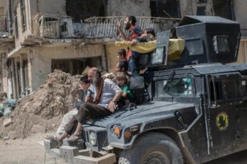 Iraqi civilians flee the ISIL-controlled old city of Mosul. Martyn Aim / Getty Images