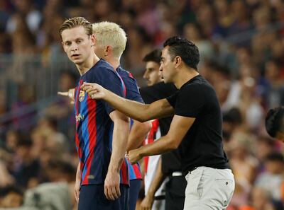 Barcelona's Frenkie de Jong with coach Xavi. Reuters