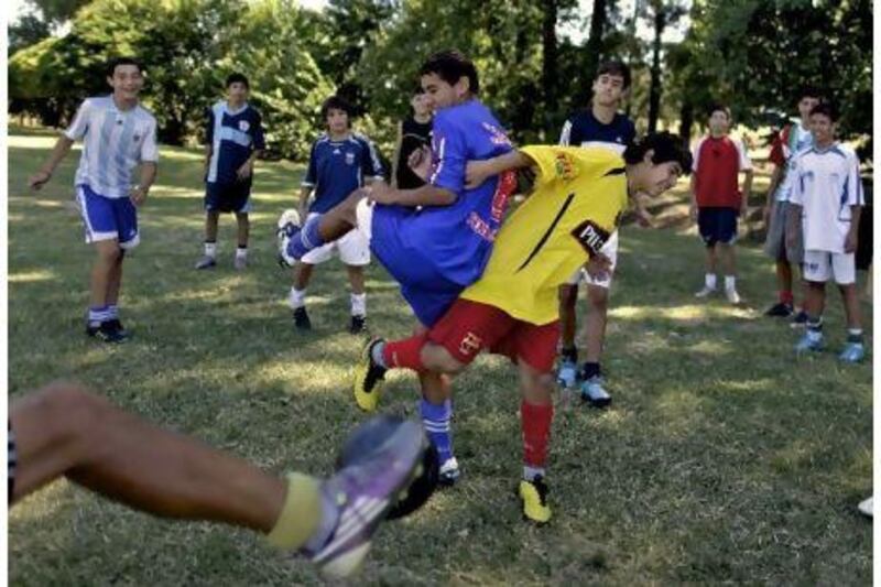 ADVANCE FOR SATURDAY JAN. 1, 2011 - In this photo taken Dec. 13, 2010, Velez Sarsfield's youth soccer players train in Buenos Aires, Argentina. Argentina exports more soccer players than any country in the world _ making stars, breaking careers but always moving millions of dollars for agents and the country's indebted clubs. (AP Photo/Natacha Pisarenko)