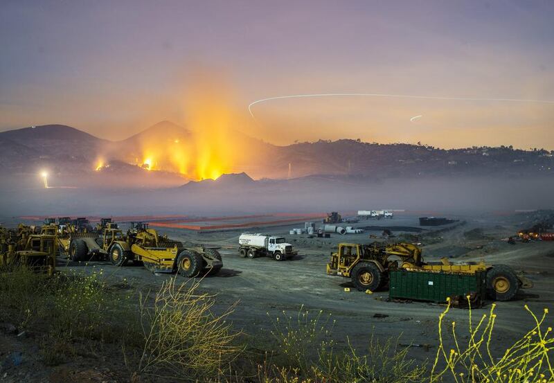 A longtime exposure shows smolderings remains of overnight fires on the hillsides of San Marcos, San Diego county, California. Stuart Palley / EPA