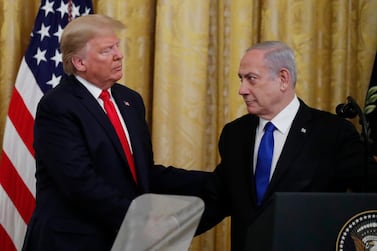 Israeli Prime Minister Benjamin Netanyahu and President Donald Trump shake hands, obscured by the top of a teleprompter, in the East Room of the White House in Washington, Tuesday, Jan. 28, 2020, to announce the Trump administration's much-anticipated plan to resolve the Israeli-Palestinian conflict. (AP Photo/Alex Brandon)