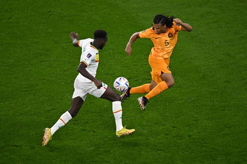 Senegal's Boulaye Dia battles with Netherlands' Nathan Ake. AFP