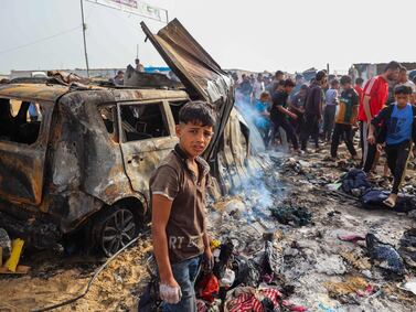 Palestinians gather at the site of an Israeli strike on a camp area housing internally displaced people in Rafah on May 27, 2024, amid ongoing battles between Israel and the Palestinian Hamas militant group. AFP