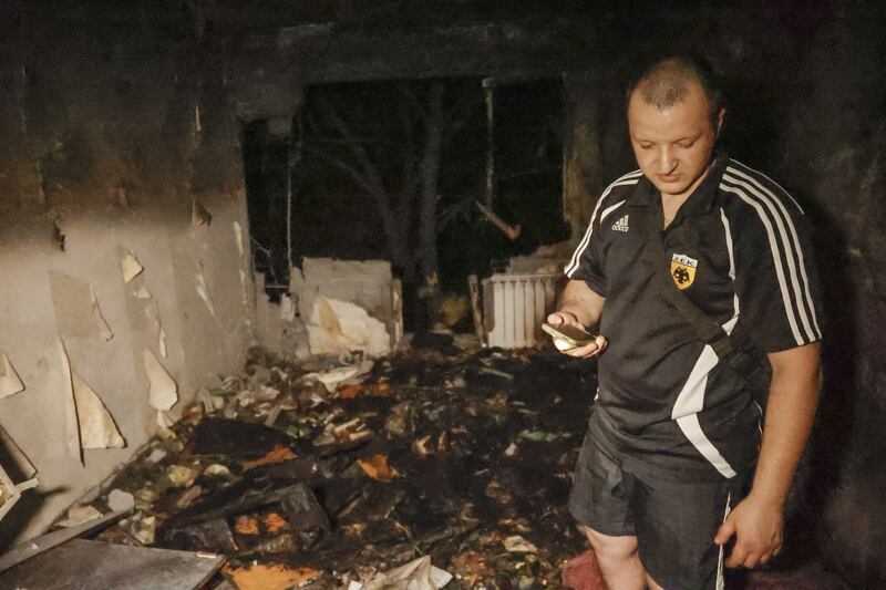 A man examines an apartment destroyed during shelling in Donetsk, eastern Ukraine. Five civilians were killed and 20 were injured. EPA