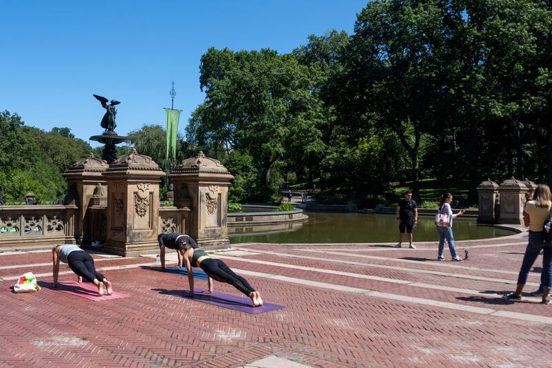 People do yoga near the flooded Bethesda Fountain in Central Park after a night of extremely heavy rain caused by Hurricane Ida on September 2, 2021, in New York City.  AFP