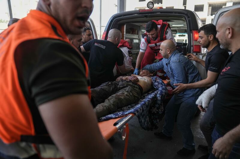 An injured Palestinian is carried into a hospital. AP