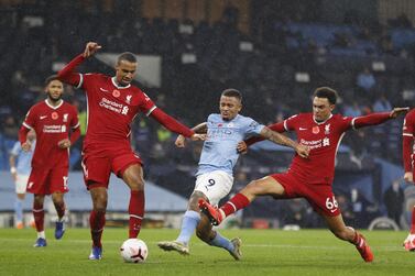 epa08808249 Manchester City's Gabriel Jesus (C) scores the 1-1 equalizer against Liverpool players Trent Alexander-Arnold (R) and Georginio Wijnaldum (L) during the English Premier League soccer match between Manchester City and Liverpool FC in Manchester, Britain, 08 November 2020. EPA/Clive Brunskill / POOL EDITORIAL USE ONLY. No use with unauthorized audio, video, data, fixture lists, club/league logos or 'live' services. Online in-match use limited to 120 images, no video emulation. No use in betting, games or single club/league/player publications.