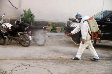 Health officials prepare the burial of a victim who died of the coronavirus in Hyderabad, Pakistan. EPA