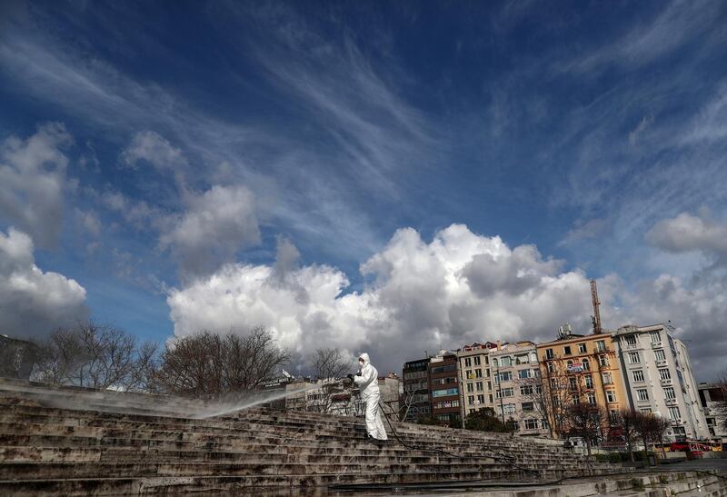 A worker disinfects stairs at the Gezi Park at Taksim Square in Istanbul, Turkey. EPA