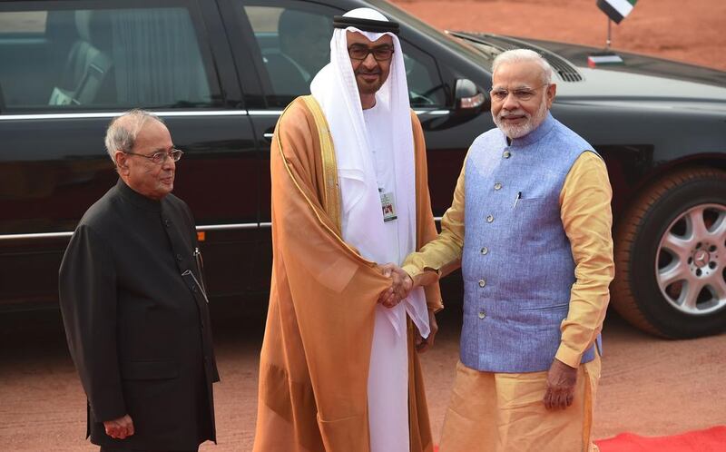 Sheikh Mohammed bin Zayed, Crown Prince of Abu Dhabi and Deputy Supreme Commander of the Armed Forces, is greeted by Indian prime minister Narendra Modi and Indian president Pranab Mukherjee before a ceremonial reception at the Indian President’s house in New Delhi on Wednesday. Money Sharma / AFP