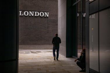 A pedestrian walks past a sign in the City of London. The Bank of England expects the unemployment rate to hit 7.5 per cent by the end of the year. Bloomberg