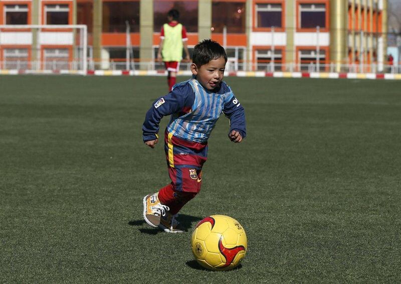 Five year-old Murtaza Ahmadi wears Barcelona's star Lionel Messi shirt made of a plastic bag as he plays soccer at the Afghan Football Federation headquarters in Kabul, Afghanistan February 2, 2016. Barcelona star Lionel Messi will meet an Afghan boy who gained Internet fame after a touching series of photographs went viral, showing him playing in a shirt improvised from a plastic bag and bearing the name and playing number of his hero. REUTERS/Omar Sobhani