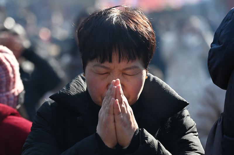A woman prays at the Lama Temple on the first day of the Lunar New Year of the Dragon in Beijing. AFP